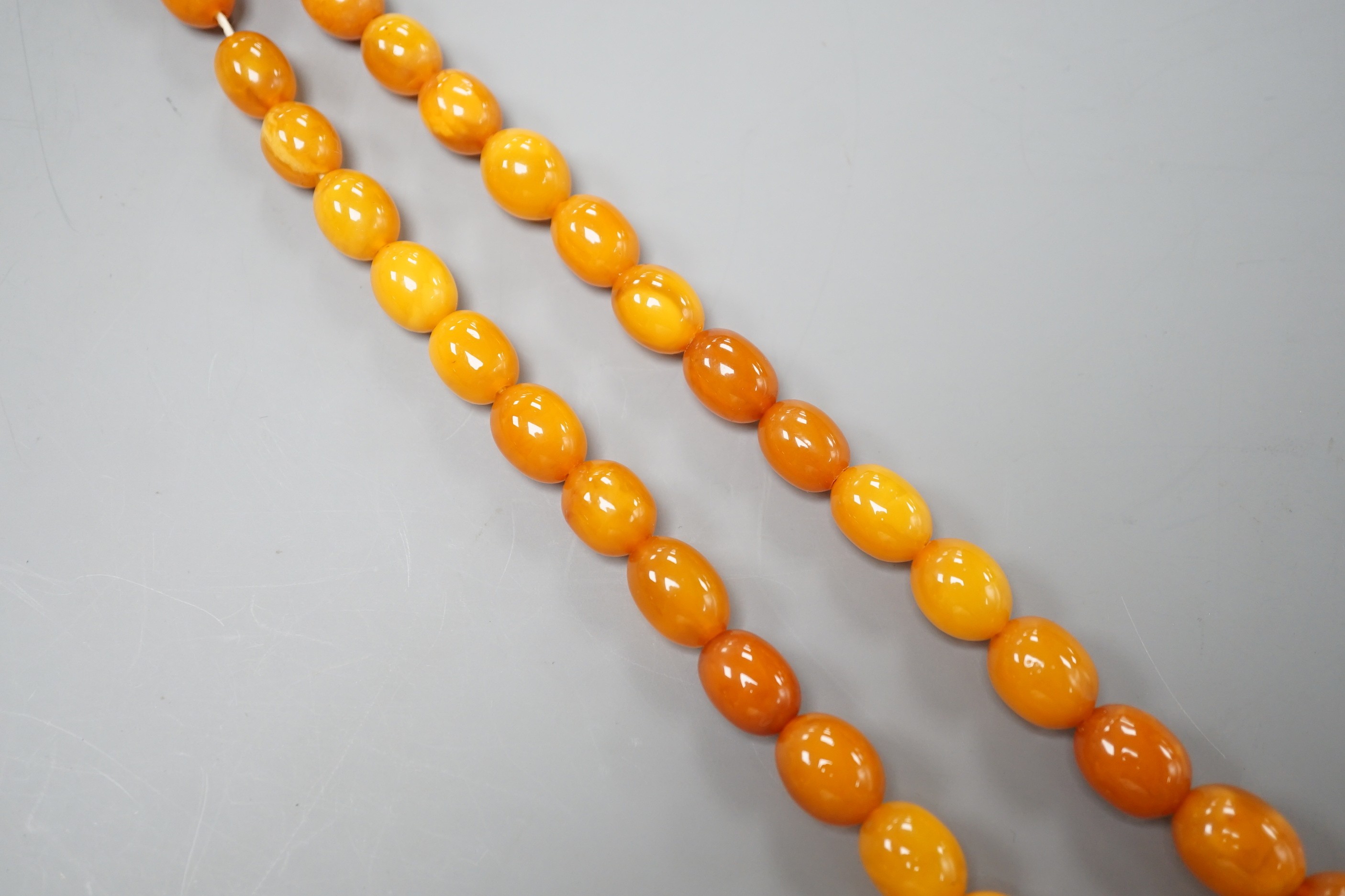 A single strand graduated oval amber bead necklace, 72cm gross weight 42 grams.